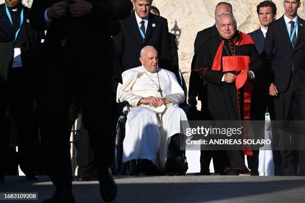 Pope Francis, next to Marseille's Archbishop and Cardinal Jean-Marc Aveline , arrives to pay homage at the memorial dedicated to sailors and migrants...