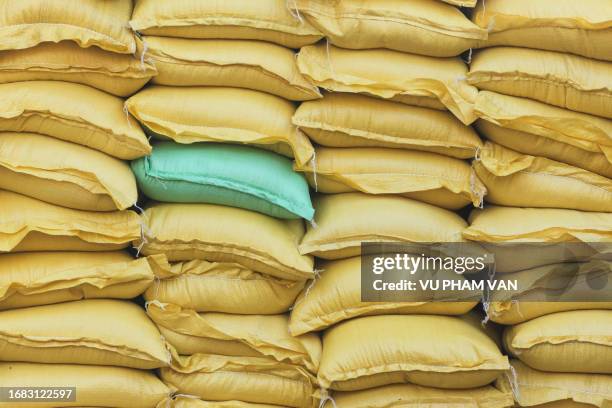 stack of rice bags after packaging in central vietnam - rice production stock pictures, royalty-free photos & images