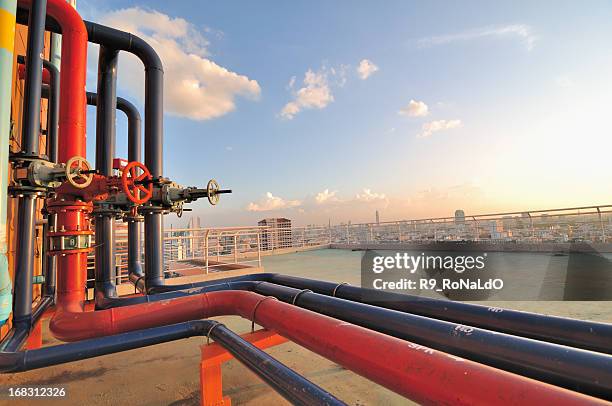 pipelines on roof top of urban factory - pipeline stock pictures, royalty-free photos & images