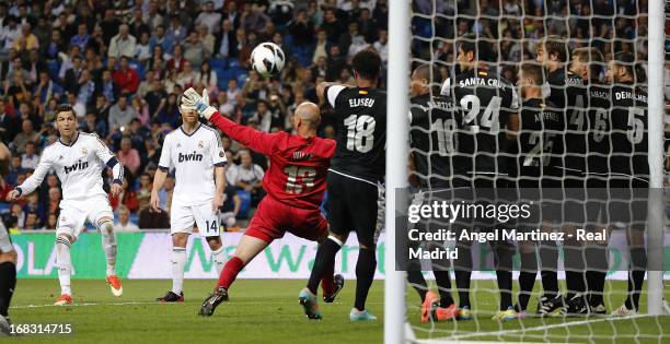 Cristiano Ronaldo of Real Madrid scores the second goal goal from a free kick during the La Liga match between Real Madrid and Malaga at Estadio...