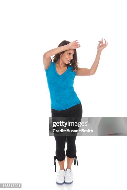 woman in athletic wear dancing against white background - dancing white background stock pictures, royalty-free photos & images