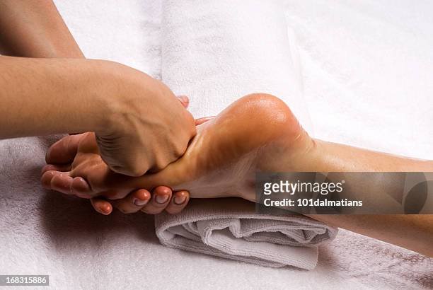 foot massage - reflexology stock-fotos und bilder