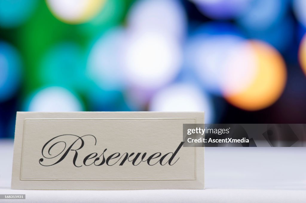 Reserved sign  with defocused lights in the background