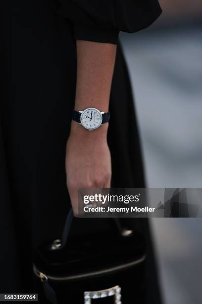 Nina Suess is seen outside the Jaeger LeCoultre cocktail party wearing diamond drop earrings, a black Zara dress with volant sleeves, a Jaeger...