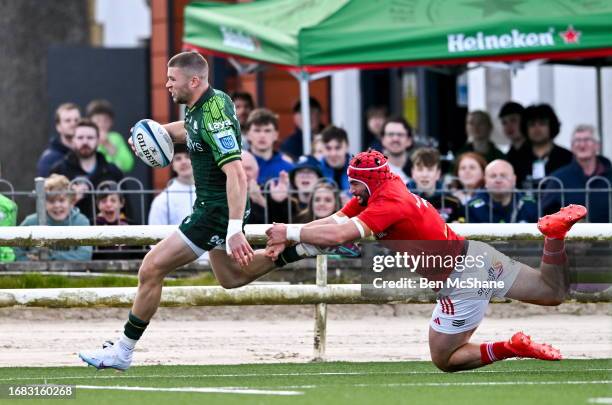 Galway , Ireland - 22 September 2023; Diarmuid Kilgallen of Connacht evades the tackle of John Hodnett of Munster on his way to scoring his side's...