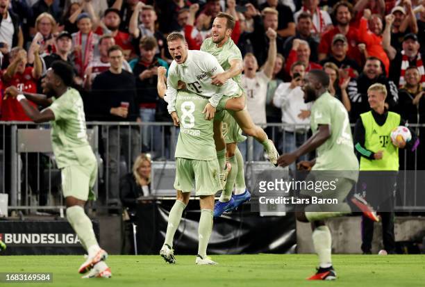 Leon Goretzka of Bayern Munich celebrates with Joshua Kimmich and Harry Kane of Bayern Munich after scoring the team's second goal during the...