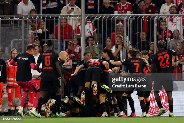 Exequiel Palacios of Bayer Leverkusen celebrates with teammates after scoring the team's second goal to equalise during the Bundesliga match between...