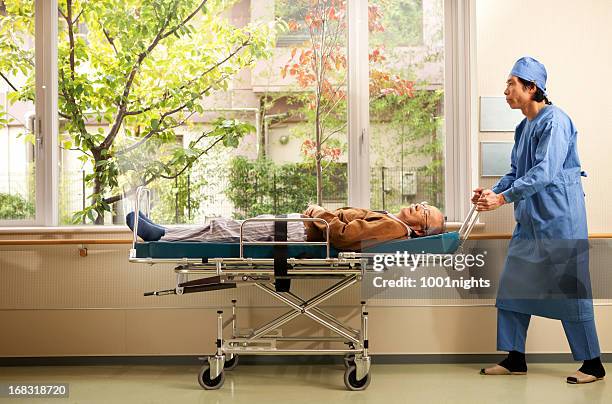 nurse and old patient - stretcher stock pictures, royalty-free photos & images