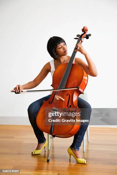 playing the cello - cello stock pictures, royalty-free photos & images