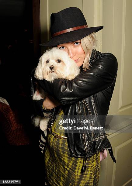 Jakki Healy holds dog Frankie Benett at a book launch party for "Pearl Lowe's Vintage Craft: 50 Craft Projects and Home Styling Advice" by Pearl Lowe...