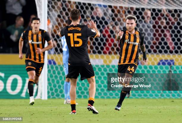 Aaron Connolly of Hull City celebrates with teammate Tyler Morton after scoring the team's first goal during the Sky Bet Championship match between...