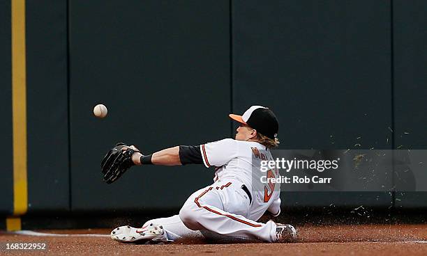 Left fielder Nate McLouth of the Baltimore Orioles misses catching a ball in foul territory hit by Elliot Johnson of the Kansas City Royals during...