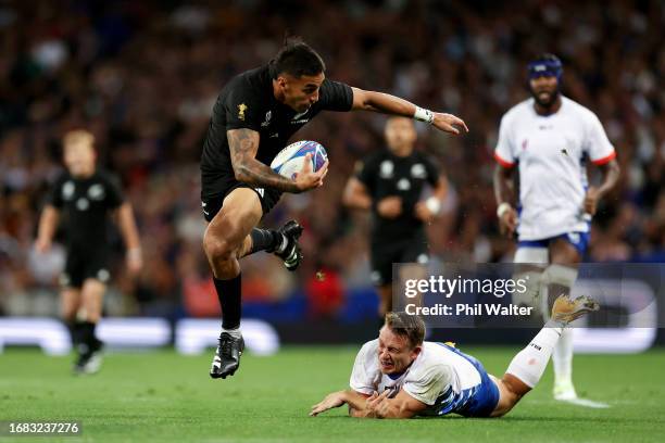 Rieko Ioane of New Zealand breaks through with the ball ahead of Tiaan Swanepoel of Namibia during the Rugby World Cup France 2023 match between New...