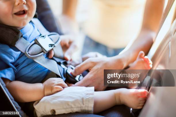 baby and mother strapping in carseat - car safety stock pictures, royalty-free photos & images