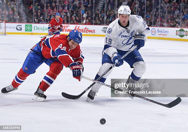 Davis Drewiske of the Montreal Canadiens and B.J. Crombeen of the Tampa Bay Lightning battle for the puck during the NHL game on April 18, 2013 at...