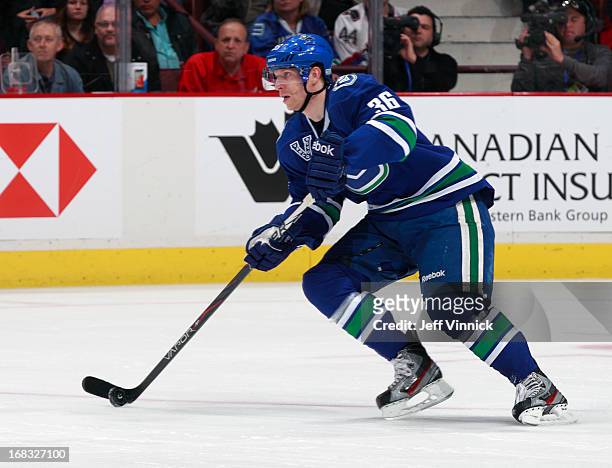 Jannik Hansen of the Vancouver Canucks skates up ice with the puck during their NHL game against the Detroit Red Wings at Rogers Arena April 20, 2013...