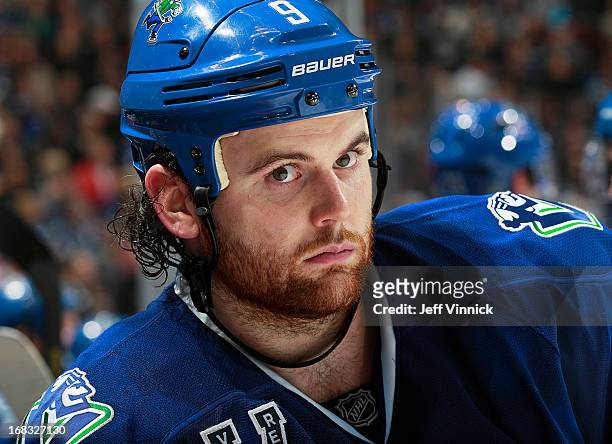 Zack Kassian of the Vancouver Canucks looks on from the bench during their NHL game against the Detroit Red Wings at Rogers Arena April 20, 2013 in...