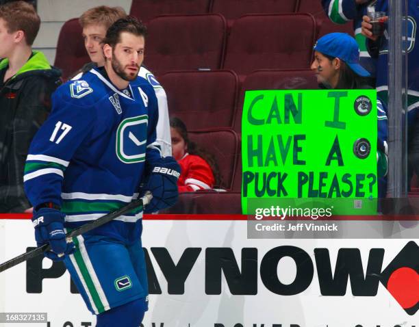 Ryan Kesler of the Vancouver Canucks skates by a fan during their NHL game against the Detroit Red Wings at Rogers Arena April 20, 2013 in Vancouver,...