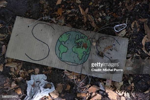 Sign reading 'SOS' is left behind after climate activists took part in the global climate strike to end fossil fuel subsidies on September 15, 2023...