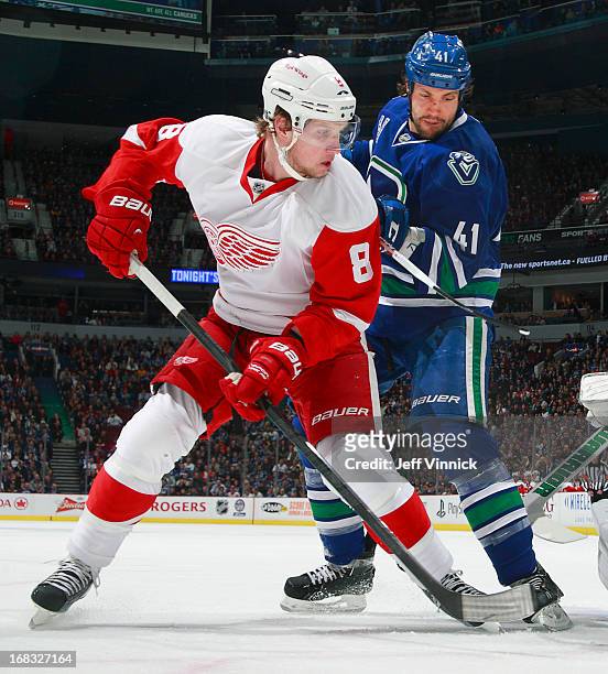 Justin Abdelkader of the Detroit Red Wings and Andrew Alberts of the Vancouver Canucks look for the rebound during their NHL game at Rogers Arena...