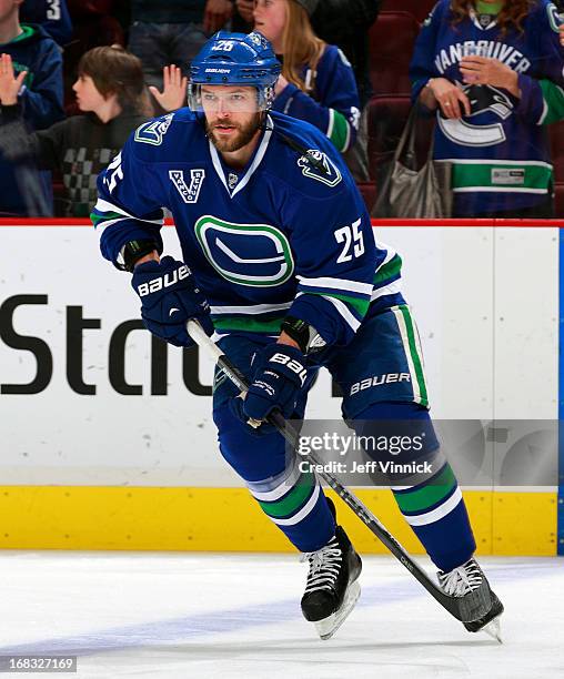 Andrew Ebbett of the Vancouver Canucks skates up ice with the puck during their NHL game against the Detroit Red Wings at Rogers Arena April 20, 2013...