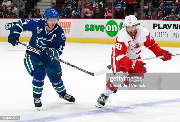 Henrik Sedin of the Vancouver Canucks and Henrik Zetterberg of the Detroit Red Wings skate up ice during their NHL game at Rogers Arena April 20,...