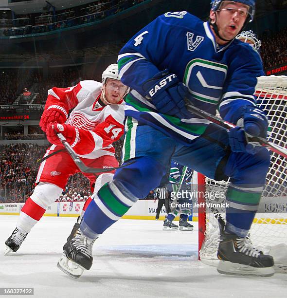 Keith Ballard of the Vancouver Canucks and Gustav Nyquist of the Detroit Red Wings battle for a loose puck during their NHL game at Rogers Arena...