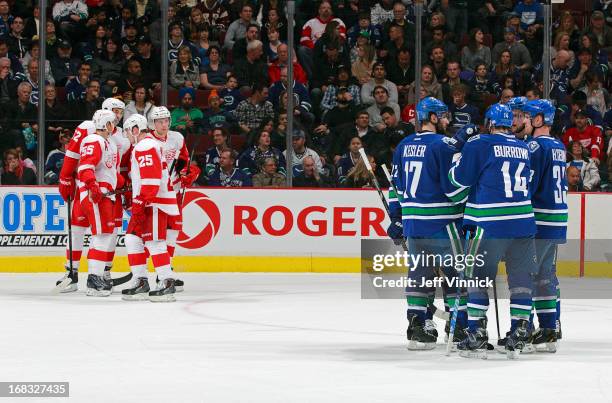 Members of the Detroit Red Wings and the Vancouver Canucks plot strategy during their NHL game at Rogers Arena April 20, 2013 in Vancouver, British...