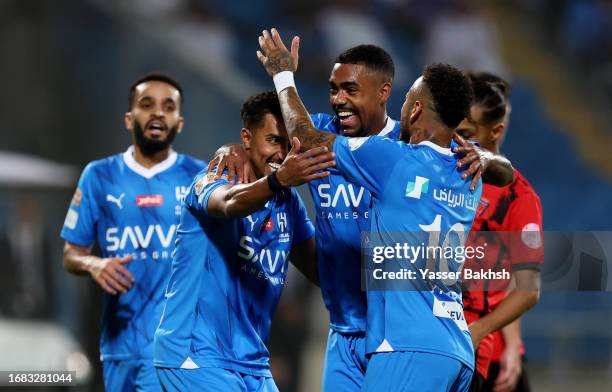 Malcom of Al Hilal celebrates after scoring the team's fourth goal with teammates Salem Al-Dawsari and Neymar Jr of Al Hilal during the match between...