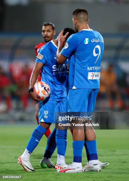 Salem Al-Dawsari of Al Hilal celebrates with teammate Aleksandar Mitrovic during the match between Al-Hilal and Riyadh at Prince Faisal Bin Fahad on...