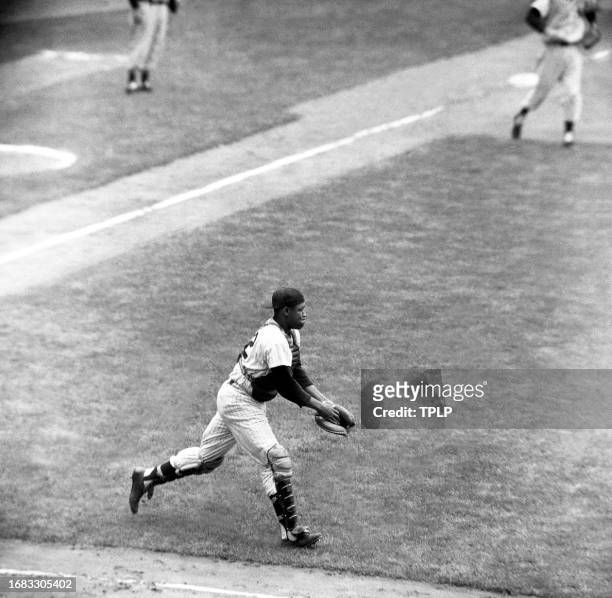 Catcher Elston Howard of the New York Yankees catches a pop-up during an MLB game against the Chicago White Sox at Yankee Stadium in the Bronx, New...