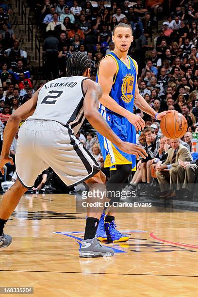 Stephen Curry of the Golden State Warriors controls the ball against Kawhi Leonard of the San Antonio Spurs in Game Two of the Western Conference...