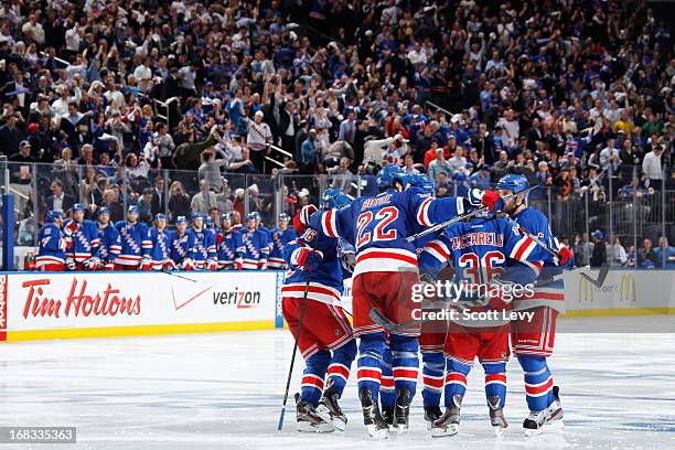 Dan Girardi, Mats Zuccarello, and Brian Boyle of the New York Rangers celebrate a third period goal against the Washington Capitals in Game Four of...