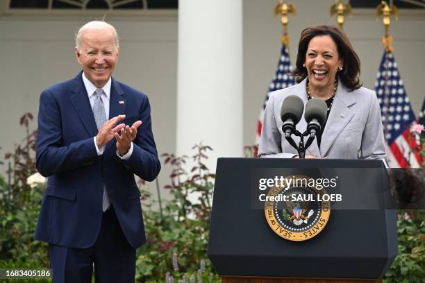 President Joe Biden applauds as Vice President Kamala Harris speaks announcing the White House Office of Gun Violence Prevention, in the Rose Garden...