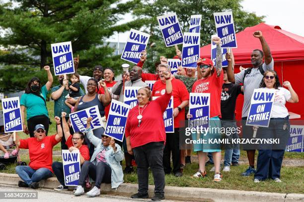 Members and workers at the Mopar Parts Center Line, a Stellantis Parts Distribution Center in Center Line, Michigan, hold signs outside the facility...