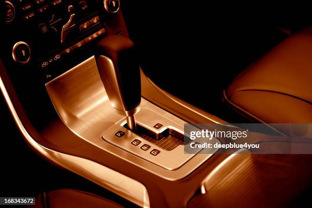 modern car automatic gearshift, red toned image - luxury cars stock pictures, royalty-free photos & images