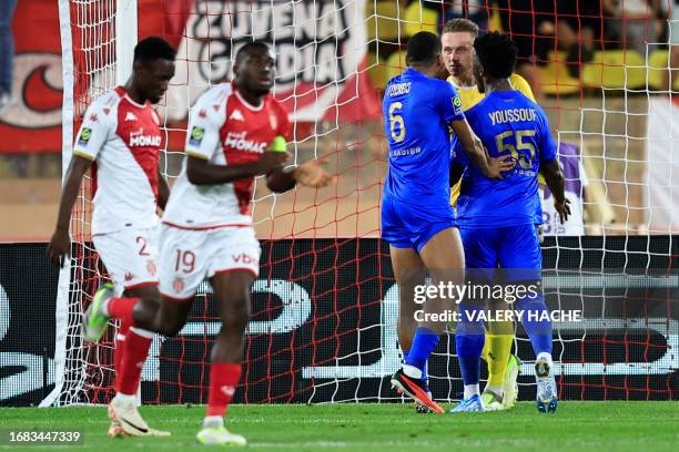 Nice's Polish goalkeeper Marcin Bulka celebrates with teammates after stopping a penalty during the French L1 football match between AS Monaco and...