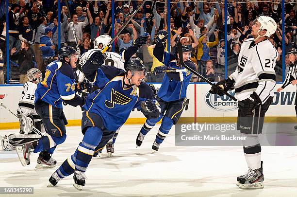 Alexander Steen, T.J. Oshie and David Backes of the St. Louis Blues celebrate as Trevor Lewis of the Los Angeles Kings looks on after Alex...