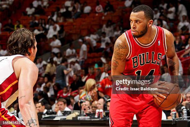 Daequan Cook of the Chicago Bulls controls the ball against Mike Miller of the Miami Heat in Game Two of the Eastern Conference Semifinals during the...