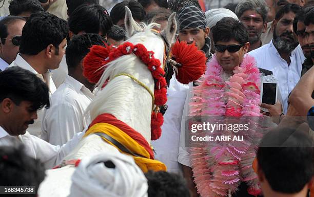 Pakistan-unrest-vote-candidate-Haq by Issam Ahmed In this photograph taken on May 8, 2013 Abrar-ul-Haq , a candidate for the national assembly for...