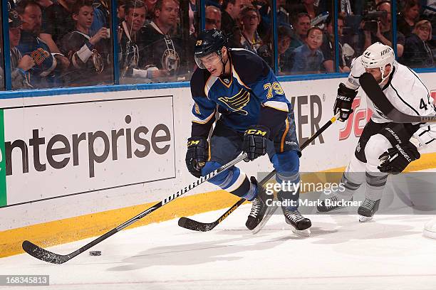 Adam Cracknell of the St. Louis Blues handles the puck as Robyn Regehr of the Los Angeles Kings gives chase in Game Five of the Western Conference...