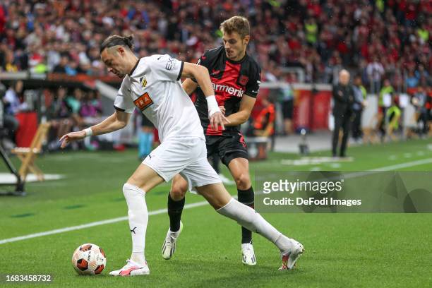 Amor Layouni of BK Haecken and Josip Stanisic of Bayer 04 Leverkusen battle for the ball during the UEFA Europa League 2023/24 group stage match...