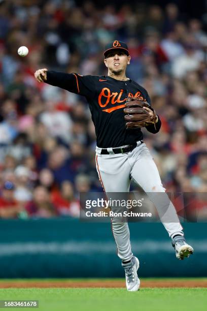 Ramon Urias of the Baltimore Orioles throws out Will Brennan of the Cleveland Guardians at first base during the third inning at Progressive Field on...