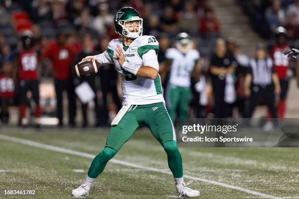 Ottawa, ON Saskatchewan Roughriders quarterback Jake Dolegala prepares to throw a pass during Canadian Football League action between the...