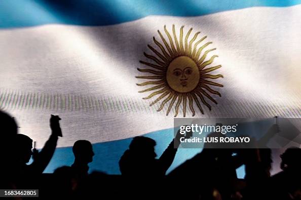 Backdropped by an Argentine flag on a screen, supporters of Argentine
