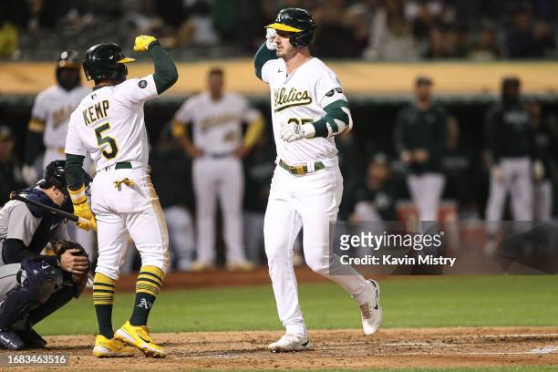 Brent Rooker and Tony Kemp of the Oakland Athletics celebrate a solo home run against the Detroit Tigers in the bottom of the sixth inning at...