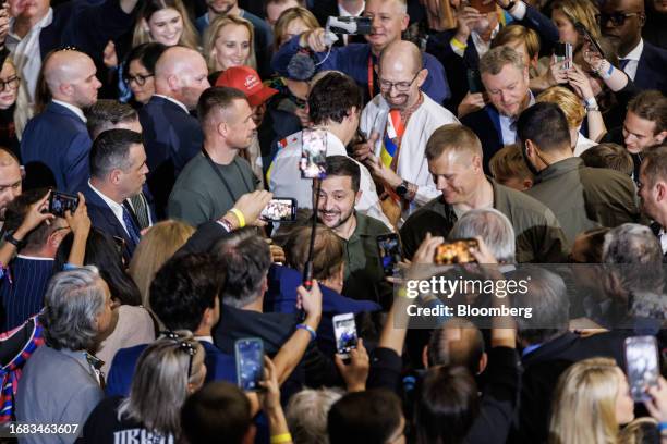 Volodymyr Zelenskiy, Ukraine's president, center, and Justin Trudeau, Canada's prime minister, center rear, greet supporters at an event in Toronto,...