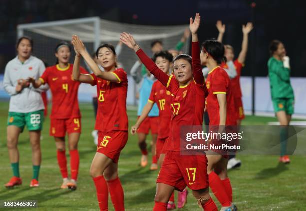 Players wave to fans during the women's soccer team's first group stage match between China and Mongolia at the Hangzhou Asian Games in Hangzhou,...