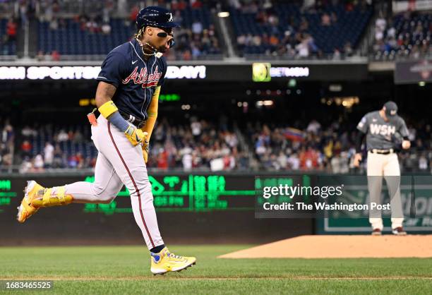 Atlanta Braves Ronald Acuna Jr. , left, heads home past Washington Nationals starting pitcher Patrick Corbin , right, after hitting a 1st inning solo...