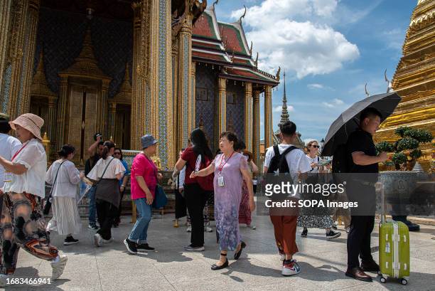 Tourists seen visiting Wat Phra Kaew in Bangkok. In an attempt to boost tourism, starting Sept. 25, the Thailand government is granting Chinese and...